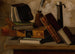 Naturaleza muerta con libros, tintero y candelabro - John Frederick Peto — vista de la obra