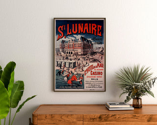 Póster vintage Bretaña – Saint-Lunaire, baños de mar, enmarcado sobre una cómoda de madera, entre plantas.