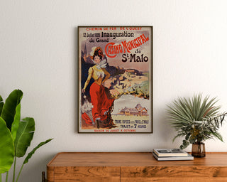 Vintage Brittany poster – Saint-Malo casino opening, framed above a wooden dresser between plants.