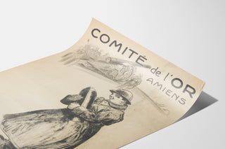 Póster histórico – Amiens, Comité de l’Or – Abel-Truchet, mostrado sobre una hoja curvada, visto en perspectiva.