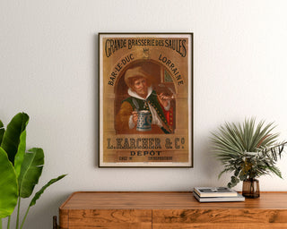 Vintage Brasserie des Saules, Bar-le-Duc advertisement, framed above a wooden dresser between plants.