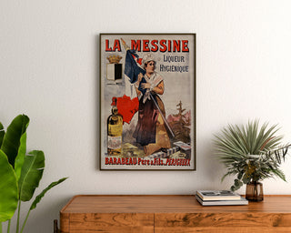 Vintage advertising poster La Messine, liqueur, framed above a wooden dresser between plants.