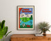 Vintage travel poster – L’Ain touristique, framed above a wooden dresser between plants.