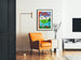 Vintage travel poster – L’Ain touristique, framed in a living room with an orange armchair and a floor lamp.
