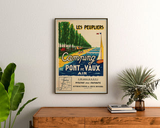 Vintage travel poster – Les Peupliers, Pont-de-Vaux campsite, framed above a wooden dresser between plants.