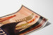 Vintage travel poster – Venezia, gondola prows, shown on a curled sheet, viewed in perspective.