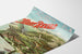 Vintage poster Aix‑les‑Bains, Mont‑Revard, rack railway, on a curled sheet, shown in perspective.