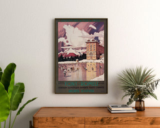 Vintage Font-Romeu winter sports poster, framed above a wooden dresser between plants.