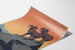 Póster vintage National Parks Preserve Wild Life, mostrado sobre una hoja curvada, visto en perspectiva.