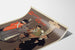 Cartel vintage Shamus O’Brien, Opera Comique, presentado sobre una hoja curvada, visto en perspectiva.