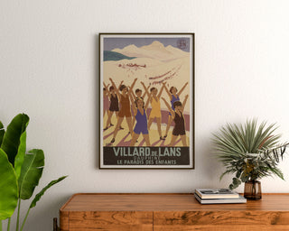 Vintage Villard-de-Lans poster, SNCF, framed above a wooden dresser between plants.