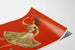 Vintage Anna Held poster in a floral dress on a red background