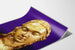 Decorative wall poster of a sculpted bust on a purple background